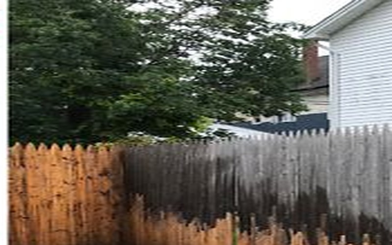 Natural wood fence after power washing
