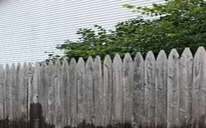 Weathered gray fence before power washing
